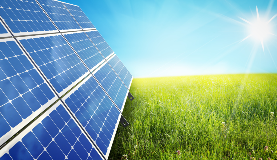 Photo of solar panels, grass and sun